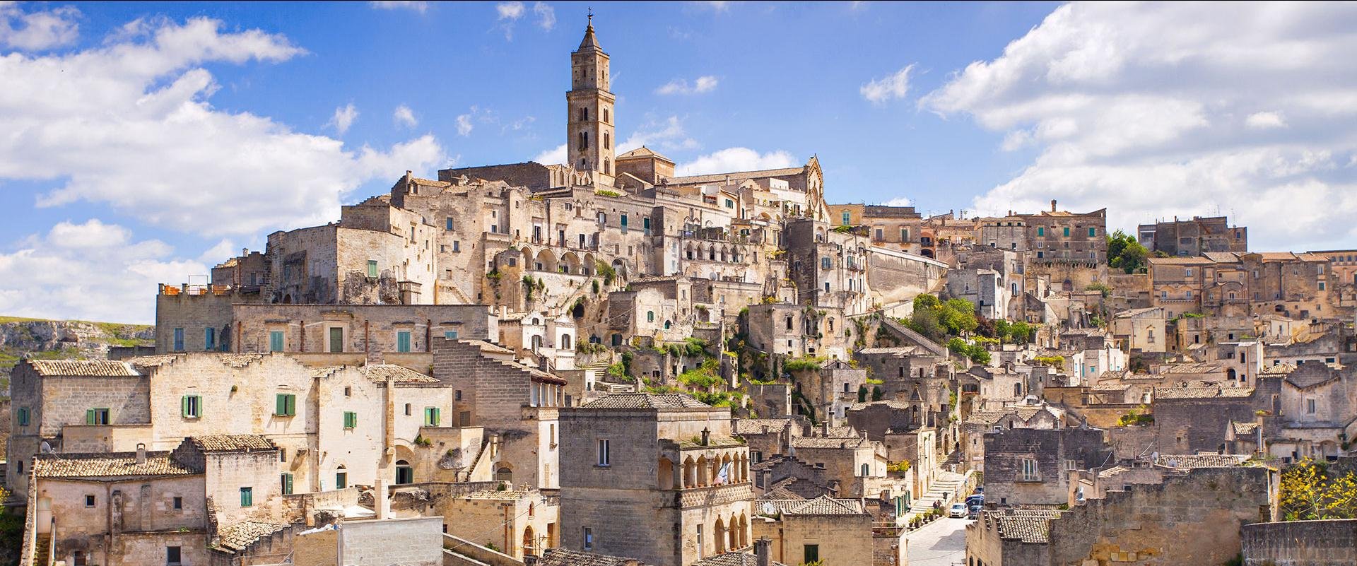 Puglia Beautiful town of Alberobello with trulli houses among green plants and flowers, main touristic district, Apulia region, Southern Italy
